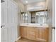 Bathroom featuring a double sink vanity with wood cabinets and a large mirror at 8235 Misty Sage St, Las Vegas, NV 89139