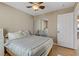 This bedroom features a bed, bedside table, mirrored closet, and a ceiling fan at 8235 Misty Sage St, Las Vegas, NV 89139