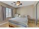 Cozy bedroom featuring a window, a ceiling fan and a mirrored closet at 8235 Misty Sage St, Las Vegas, NV 89139