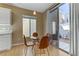 Cozy dining area with a modern table and chairs, adjacent to sliding glass doors at 8235 Misty Sage St, Las Vegas, NV 89139