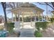 A white gazebo is framed by green landscaping in a tranquil community setting at 8235 Misty Sage St, Las Vegas, NV 89139