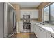 A modern kitchen features stainless steel appliances and a bright window with a view at 8235 Misty Sage St, Las Vegas, NV 89139