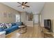 Comfortable living room featuring hardwood floors, a ceiling fan, and neutral-colored walls at 8235 Misty Sage St, Las Vegas, NV 89139