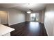 Open-concept living area with wood floors and sliding glass doors at 8255 Las Vegas Blvd # 415, Las Vegas, NV 89123