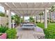 Community outdoor kitchen area with a built-in barbecue grill and dining table beneath a pergola at 8255 Las Vegas Blvd # 415, Las Vegas, NV 89123