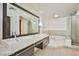 Modern bathroom featuring double sinks, soaking tub, and glass-enclosed shower at 8925 W Flamingo Rd # 110, Las Vegas, NV 89147