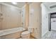 A bathroom featuring a tub/shower combo and a view of the laundry room at 8925 W Flamingo Rd # 110, Las Vegas, NV 89147