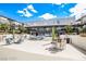 Courtyard featuring comfortable outdoor seating, manicured greenery, and clear blue sky at 8925 W Flamingo Rd # 110, Las Vegas, NV 89147