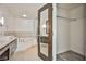 Open bathroom with dual vanities, a luxurious soaking tub, and ample storage at 8925 W Flamingo Rd # 110, Las Vegas, NV 89147