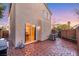 The back patio with brick pavers features a sliding glass door and outdoor air conditioning unit at 9151 Mount Wilson St, Las Vegas, NV 89113