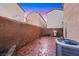 A brick-paved back patio features an air conditioning unit, brick wall and outdoor grill at 9151 Mount Wilson St, Las Vegas, NV 89113