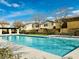 Community swimming pool surrounded by sun loungers, manicured grass and clear blue skies at 9151 Mount Wilson St, Las Vegas, NV 89113