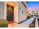 Close-up of the front door with covered entryway, landscaping, and sidewalk at 9151 Mount Wilson St, Las Vegas, NV 89113