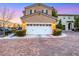 Inviting two-car garage with manicured shrubs, and a beautiful brick driveway at 9151 Mount Wilson St, Las Vegas, NV 89113