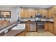 A close up view of the kitchen featuring light wood cabinets and stainless steel appliances at 9151 Mount Wilson St, Las Vegas, NV 89113