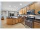 Kitchen view showcasing wood cabinets, stainless steel oven and microwave, and neutral countertops at 9151 Mount Wilson St, Las Vegas, NV 89113