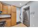 Galley kitchen with stainless steel refrigerator and wooden cabinets, offering ample storage space at 9151 Mount Wilson St, Las Vegas, NV 89113