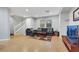 Open-concept living room featuring hardwood floors, a comfortable couch, and natural light at 9151 Mount Wilson St, Las Vegas, NV 89113