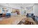 View of an open-concept living area with hardwood floors, light gray walls, and stainless steel appliances at 9151 Mount Wilson St, Las Vegas, NV 89113