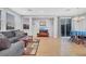 A view of the living room featuring a grey sofa set, a sliding glass door and wooden floors at 9151 Mount Wilson St, Las Vegas, NV 89113