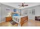 Spacious main bedroom featuring a ceiling fan, wood floors, and large windows at 9151 Mount Wilson St, Las Vegas, NV 89113