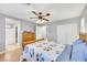 Bright main bedroom with ceiling fan, closet doors, and light-colored hardwood floors at 9151 Mount Wilson St, Las Vegas, NV 89113