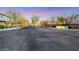 Street view of the Trail Ridge neighborhood entrance at dusk with trees, walkways, and lighting at 9151 Mount Wilson St, Las Vegas, NV 89113