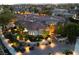 Beautiful home with an aerial view showing the red tiled roof and lush landscaping illuminated at twilight at 9825 Glenrock Dr, Las Vegas, NV 89134