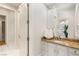 Elegant bathroom featuring granite countertops, custom vanity, and a view into the walk-in closet at 9825 Glenrock Dr, Las Vegas, NV 89134