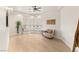 Bedroom with hardwood floors, natural light, and a comfortable seating area by the window at 9825 Glenrock Dr, Las Vegas, NV 89134