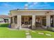 Backyard patio with outdoor kitchen and living space, perfect for entertaining and relaxing by the pool at 9825 Glenrock Dr, Las Vegas, NV 89134