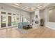 Elegant living room with hardwood floors, fireplace, and doors leading to the outdoor space at 9825 Glenrock Dr, Las Vegas, NV 89134