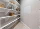 Organized pantry features white shelving, baskets, and ample storage space for convenient kitchen organization at 9825 Glenrock Dr, Las Vegas, NV 89134