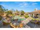 Backyard pool area with lounge chairs, lush landscaping, and a serene setting for relaxation at 9825 Glenrock Dr, Las Vegas, NV 89134