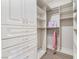 Spacious walk-in closet featuring custom shelving, drawers, and ample storage for clothes and accessories at 9825 Glenrock Dr, Las Vegas, NV 89134