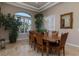 Traditional dining room featuring tan walls, travertine floors, and a beautiful wood table set perfect for gatherings at , Las Vegas, NV 89149