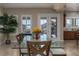 Bright dining room with natural light, a modern glass table, comfortable seating, and views of the outdoor area at 4830 Byzantine Ct, Las Vegas, NV 89149