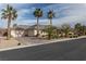 A full front view shows desert landscaping, mature palm trees, and a three-car garage at 4830 Byzantine Ct, Las Vegas, NV 89149