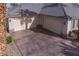 This angle highlights a spacious three-car garage with an extra wide driveway at 4830 Byzantine Ct, Las Vegas, NV 89149