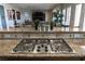 Close up on kitchen with gas cooktop, granite countertops, tile backsplash, and plants on the breakfast bar at 4830 Byzantine Ct, Las Vegas, NV 89149