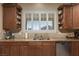 This kitchen features custom cabinets, granite countertops, stainless steel appliances, and a window with shutter-style blinds at , Las Vegas, NV 89149