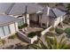 Aerial view of a tranquil outdoor patio space with fireplace and lush landscaping at 4830 Byzantine Ct, Las Vegas, NV 89149