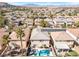 Aerial view of a residential area with a pool and well-maintained homes with lush landscaping, and mountain views at 11004 Dornoch Castle St, Las Vegas, NV 89141