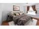Cozy bedroom featuring a tufted headboard, decorative pillows, and matching nightstands at 1301 E St Louis Ave # C, Las Vegas, NV 89104