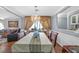 Formal dining room with chandelier, window drapes, and seating for six at 1301 E St Louis Ave # C, Las Vegas, NV 89104