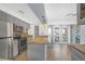 Galley kitchen with stainless steel appliances, gray cabinets and access to the back patio at 1301 E St Louis Ave # C, Las Vegas, NV 89104