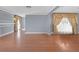 Bright living room featuring hardwood floors, custom wall trim and decorative window treatments at 1301 E St Louis Ave # C, Las Vegas, NV 89104