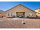 The backyard features a covered patio with an outdoor kitchen, seating area, and well-kept gravel at 1484 Midnight Cowboy Ct, Las Vegas, NV 89110