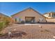 Wide shot of the property's backyard showing the spacious covered patio and well-maintained gravel landscape at 1484 Midnight Cowboy Ct, Las Vegas, NV 89110