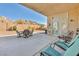 Covered patio with outdoor seating, offering a serene and relaxing backyard setting at 1484 Midnight Cowboy Ct, Las Vegas, NV 89110